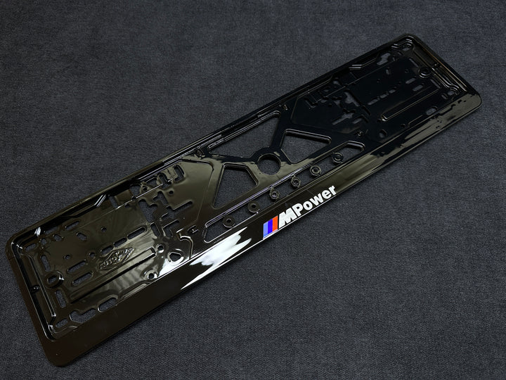 A black license plate frame with 'M Power' branding for BMW vehicles.