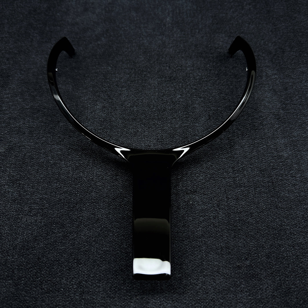 A black steering wheel middle trim with a glossy finish, designed for a BMW F-Series vehicle