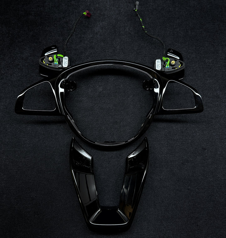 A black steering wheel trim set with shift paddles 