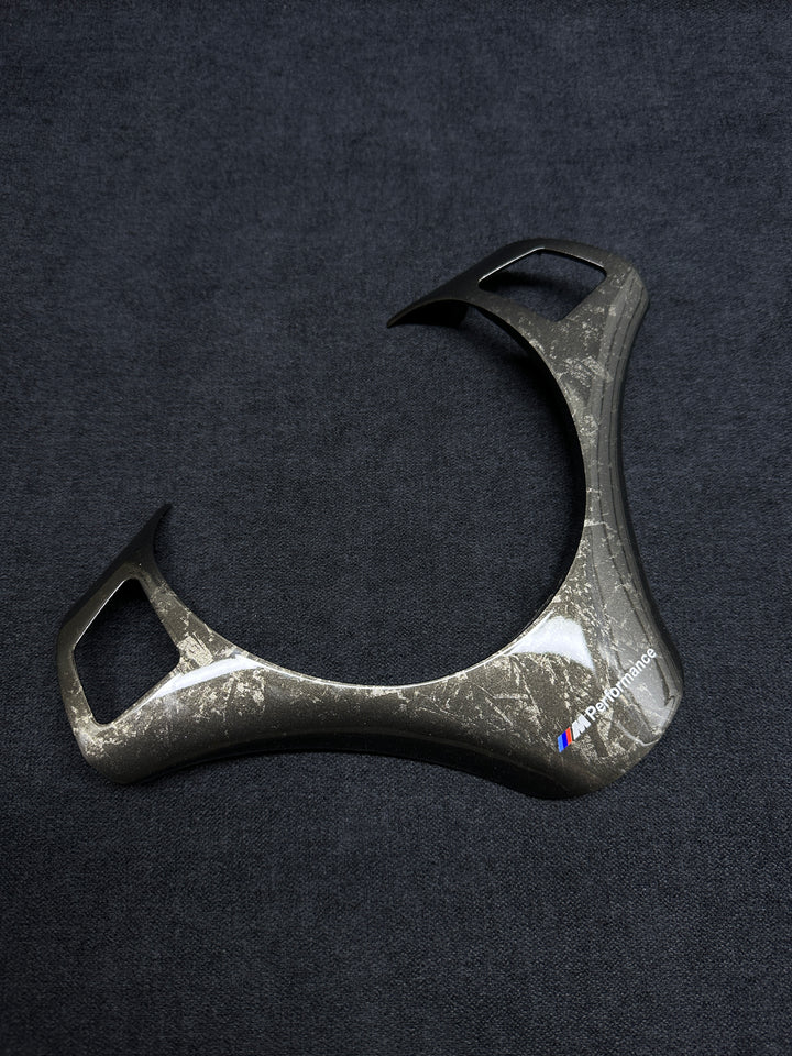 A forged carbon style steering wheel trim with a textured finish Performance BMW