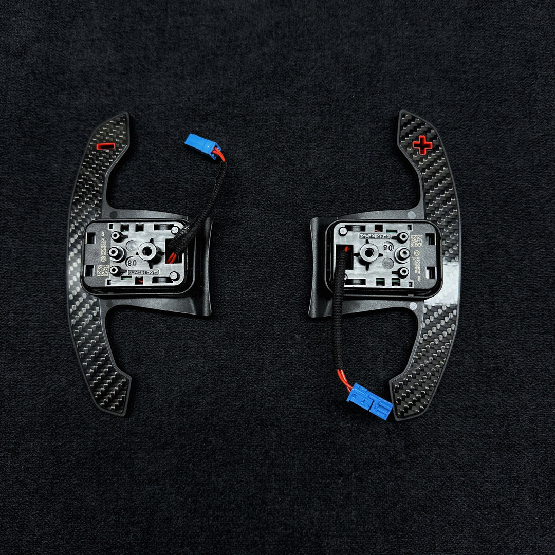 A pair of carbon style shift paddles for bmw g series