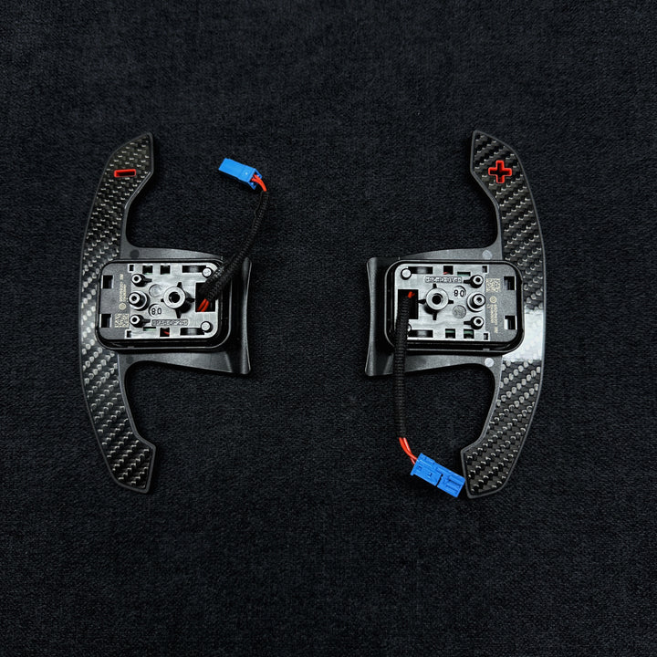 A pair of carbon style shift paddles for bmw g series