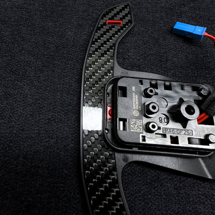 A pair of carbon style shift paddles for bmw g series steering wheel