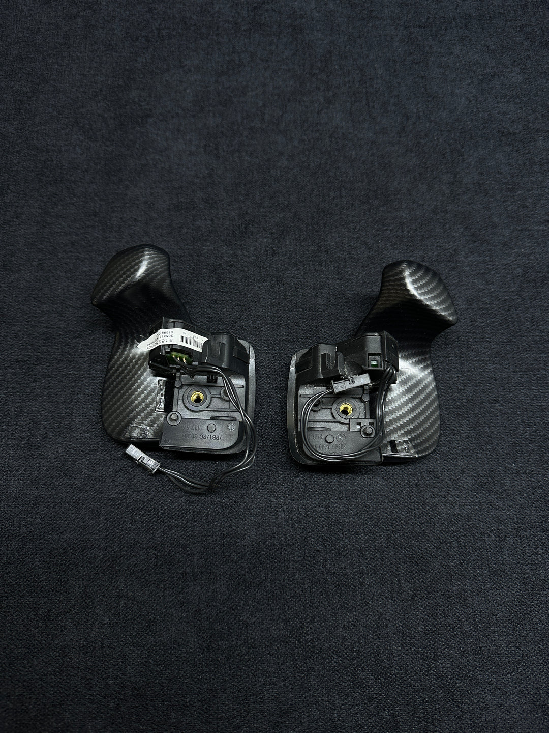 A pair of matte carbon style shift paddles for a BMW vehicle