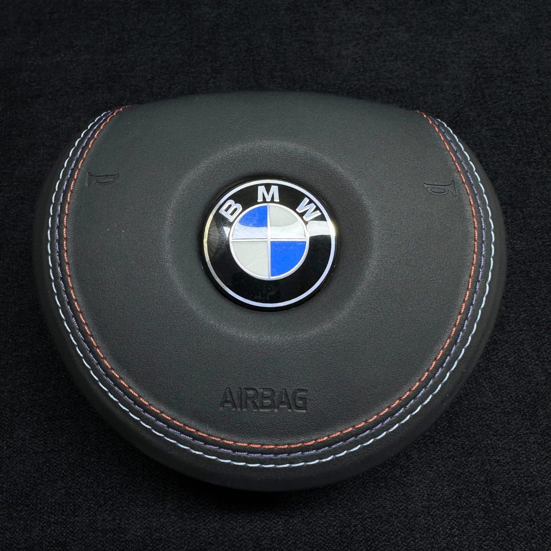 BMW airbag cover with logo on a black background M stitching