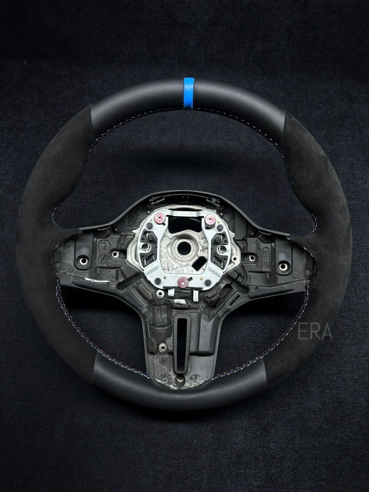 BMW leather steering wheel with a light blue stripe and black stitching, designed for BMW vehicles, showing the wheel's interior 