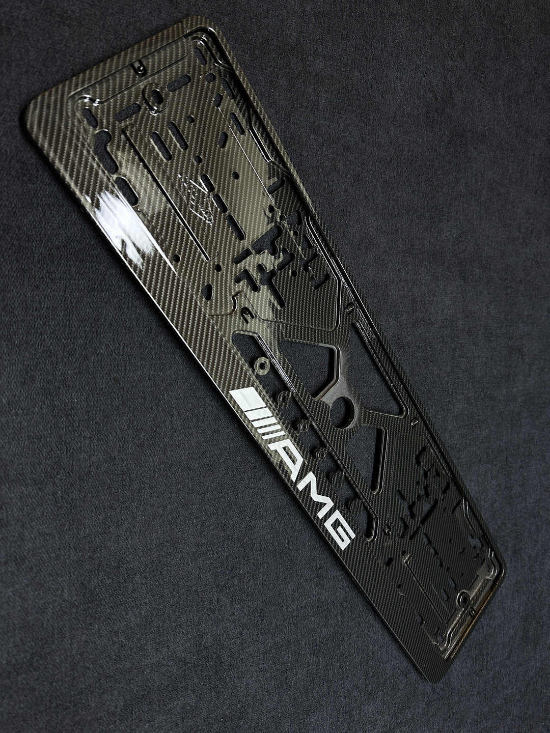 Carbon fiber license plate frame for Mercedes-Benz with a textured design and AMG LOGO