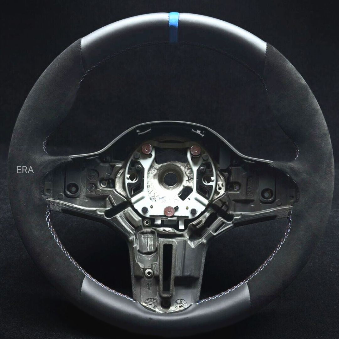 Custom BMW leather steering wheel with a light blue stripe and black stitching, designed for BMW vehicles, showing the wheel's interior 
