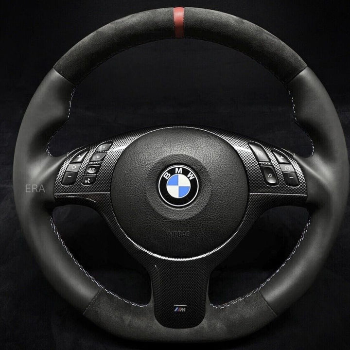 Custom steering wheel for BMW with red stitching, carbon fibre trim, and flat bottom design.