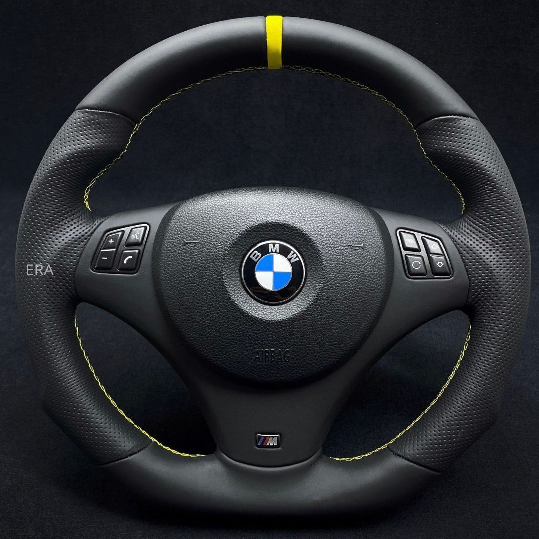 Custom steering wheel for BMW with yellow stitching and stripe on the top