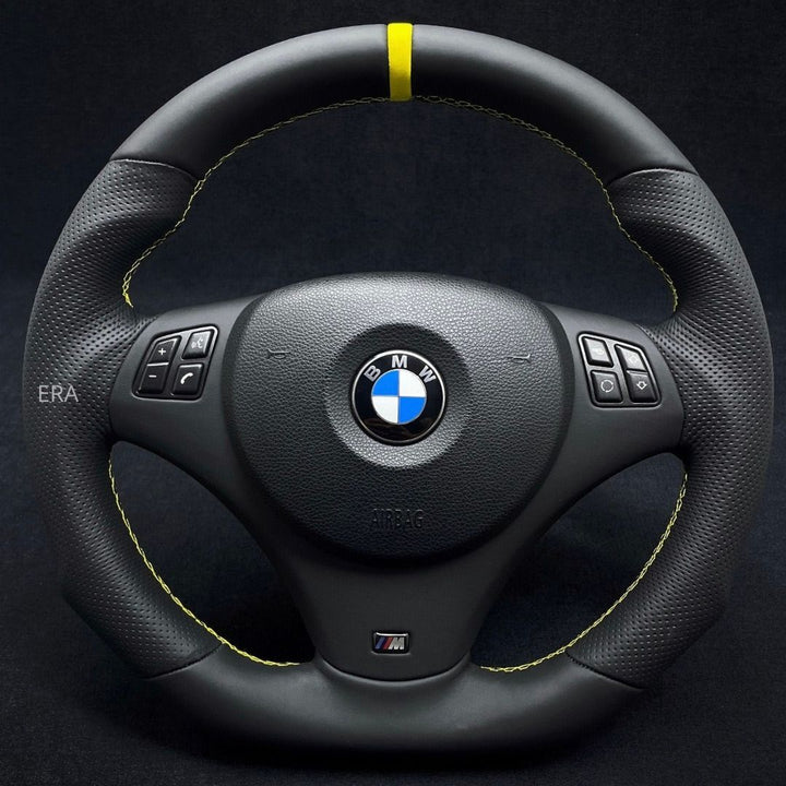 Custom steering wheel for BMW with yellow stitching and stripe on the top