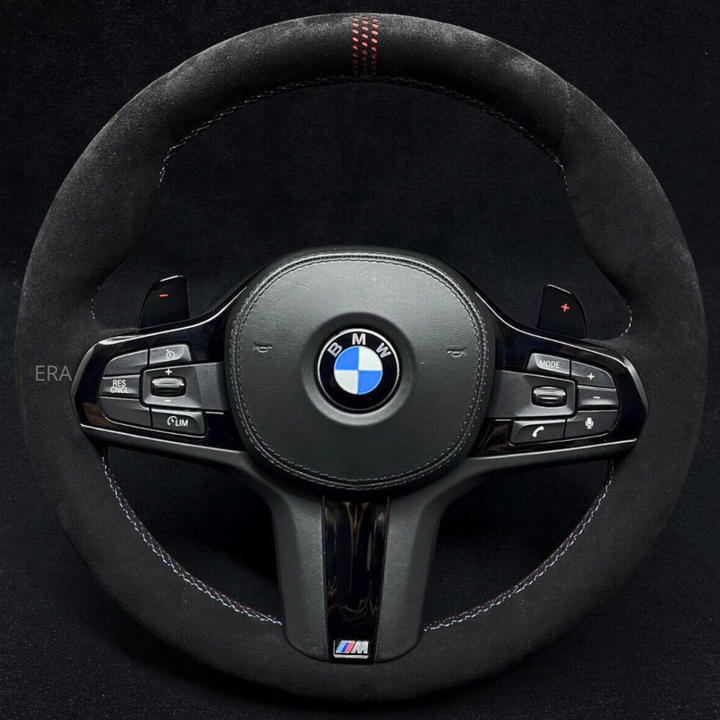 A black BMW steering wheel with red stitching, white stitching, and black trim. The steering wheel features the BMW logo at the center and ERA branding on the bottom.