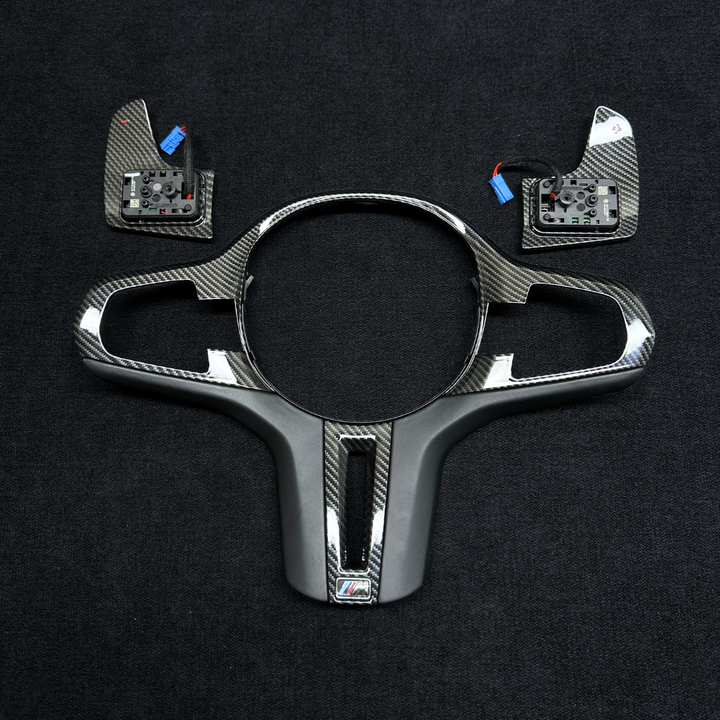 Chrome car dashboard trim with BMW logo on a black background