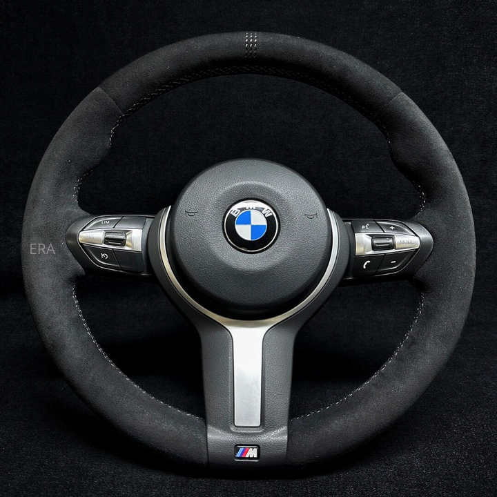 Custom steering wheel for BMW with gray Alcantara texture, gray laser stripes, and gray stitching.