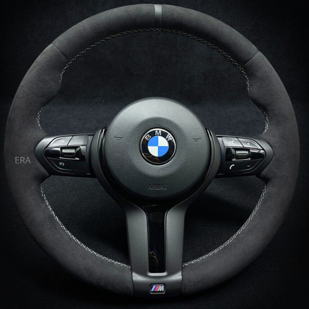 BMW steering wheel with logo on a black background grey stripe