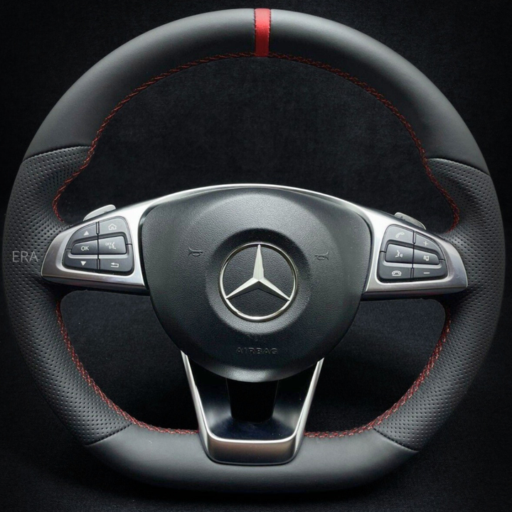 Mercedes-Benz steering wheel with red stitching on a black background