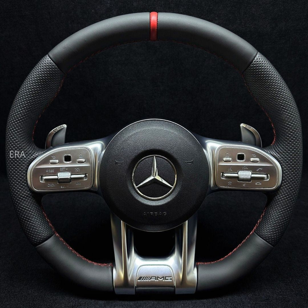 Customized steering wheel with red stitching, black leather, and shift paddles, featuring a carbon fiber and metal finish