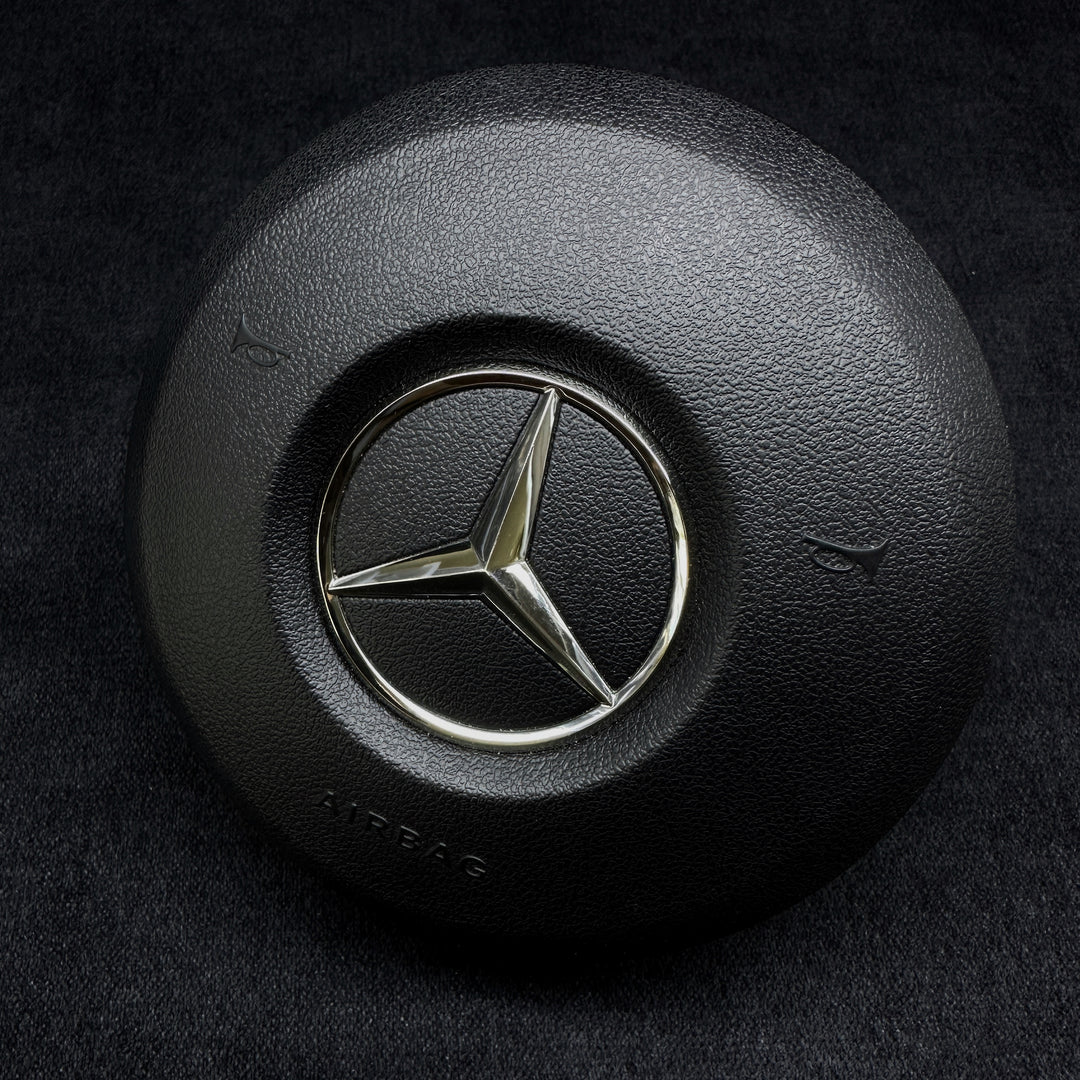 black Mercedes-Benz steering wheel airbag