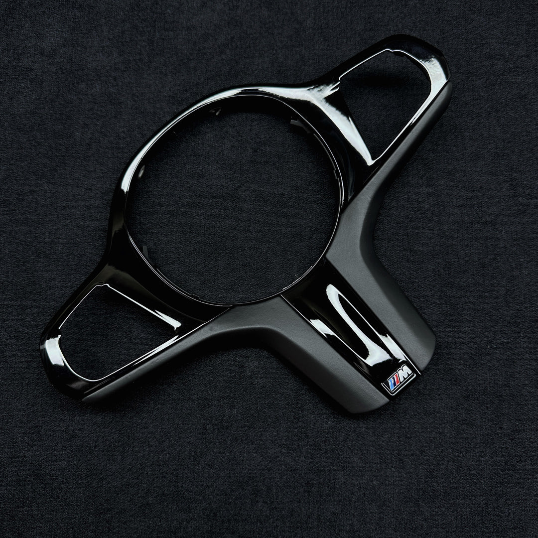 black piano trim piece for a BMW vehicle steering wheel