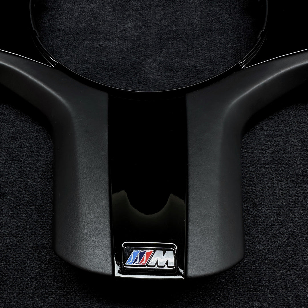 black piano trim piece for a BMW vehicle steering wheel m performance