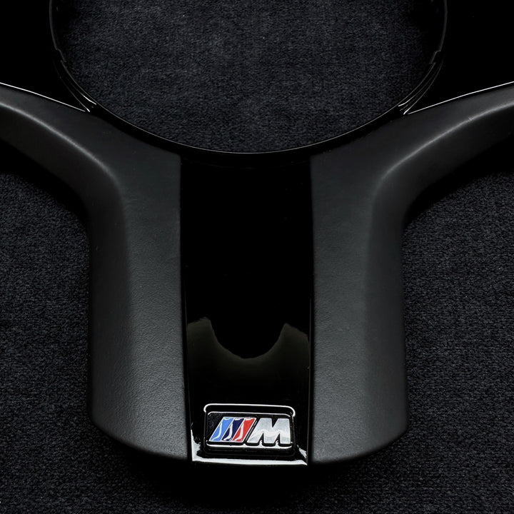 black piano trim piece for a BMW vehicle steering wheel m performance
