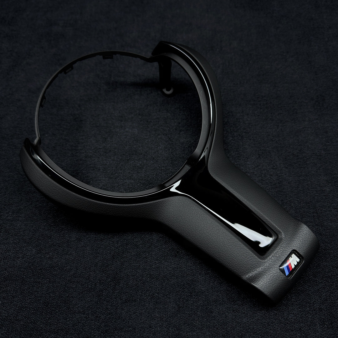 black steering wheel trim with the BMW M brand logo in the center