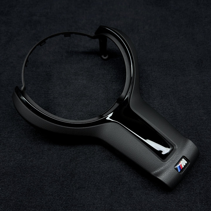 black steering wheel trim with the BMW M brand logo in the center
