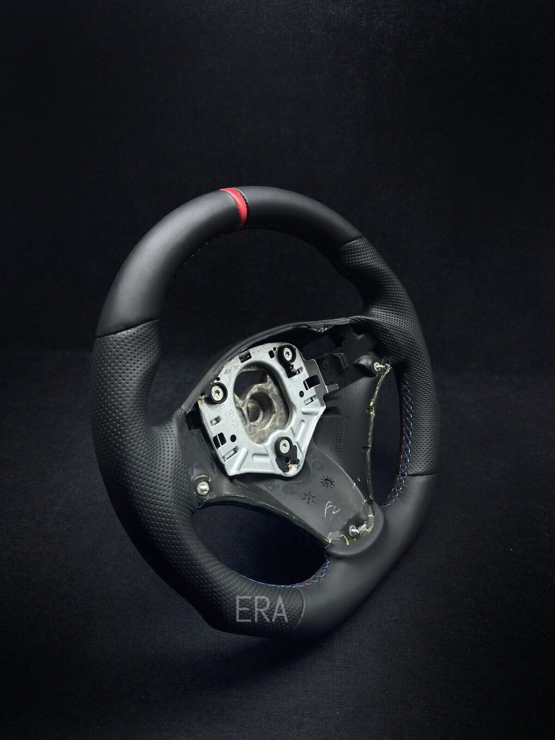 perforated leather steering wheel with a red stripe and M stitching, designed for BMW